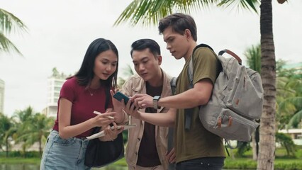 Low angle view of students helping freshman to find library in campus area