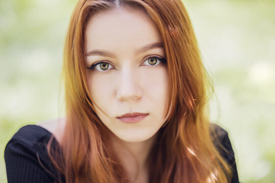 Portrait of beautiful young redhead woman with red hair.
