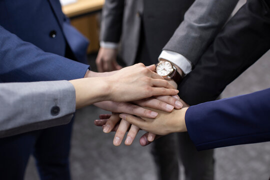 Confident Chinese business people cheering in office