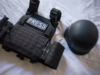 bullet proof vest and helmet for war zone coverage on the bed in hotel in kyiv