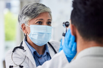 Woman, doctor and face mask with patient for exam, checkup or healthcare appointment at hospital....