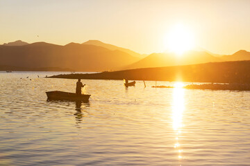 Fototapeta na wymiar Fisherman on sunrise