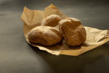 Closeup of home made bread on brown paper. Natural light - 622297641
