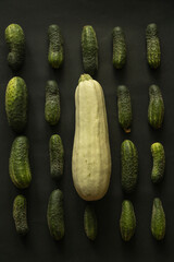 Flat lay with perfect organized cucumbers and zucchini on black background - 622298073