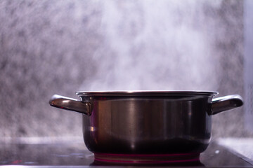 metal saucepan on a stone tabletop background