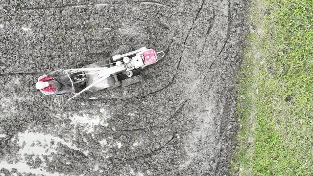 Plough is cultivated with mini tractors on agricultural land in Bangladesh