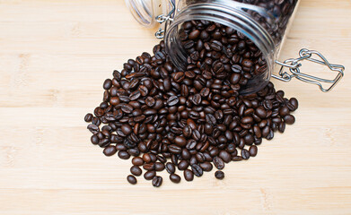 Raw coffee beans on wooden table top, close-up shot above. before drinking