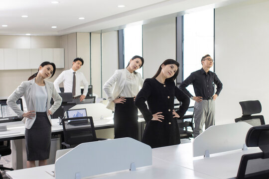 Chinese Business People Exercising In Office