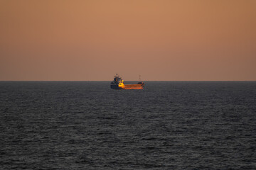 Seascape, a lonely tanker in the Baltic Sea near the coast of Estonia at sunset.