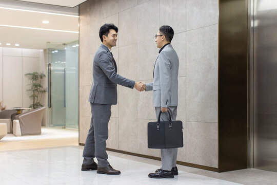 Successful Chinese business people shaking hands