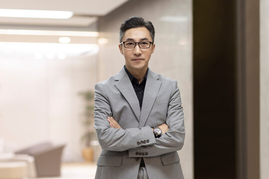 Portrait of successful Chinese businessman in office