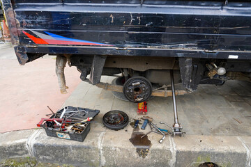 Truck drum brake system undergoing repair, showcasing a slightly chilling scene with a hanging doll...