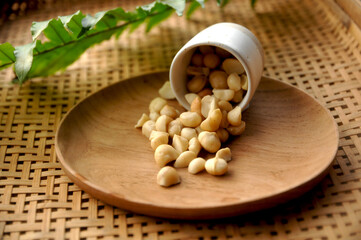 wooden bowl of macadamia nuts