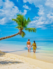 Mahe Seychelles, a tropical beach with palm trees, and a blue ocean at Mahe Seychelles. Anse Royale beach, couple man and woman on vacation Seychelles