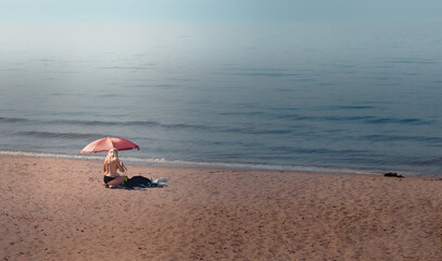 person on the beach,lonely naked woman under a beach umbrella