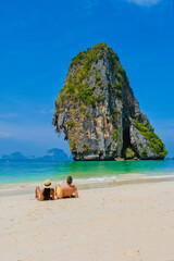 Fototapeta premium a couple of men and women on the beach of Railay Krabi Thailand, Panoramic view of idyllic Railay Beach in Thailand