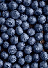 Blueberries on grunge wooden kitchen board. Natural healthy food. Still life photography