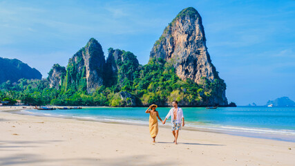 men and women relaxing on the beach during a vacation in Thailand Railay Beach Krabi.