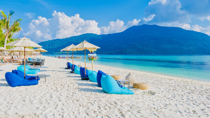 Fototapeta na wymiar beach chairs at the beach of Koh Kradan island in Thailand on a sunny day on the beach