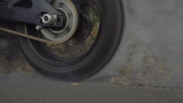 Slow Motion Racing sports bike burning tires on speed track close-up, HD B-Roll footage