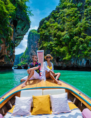 Luxury Longtail boat in Krabi Thailand, couple man, and woman on a trip at the tropical island 4 Island trip in Krabi Thailand. Asian woman and European man mid age on vacation in Thailand. - obrazy, fototapety, plakaty
