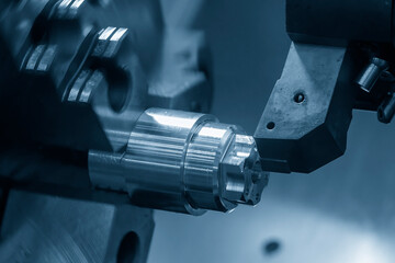 The  CNC lathe machine face  cutting the metal shaft parts.