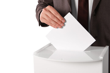 Man putting his vote into ballot box on white background, closeup