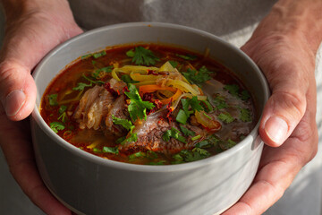 person holding a bowl of soup