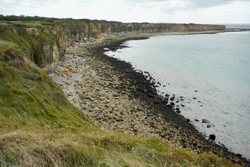 View of the coast at Pointe du Hoc, France, July 2023. Sea, beach, cliffs and blue skies. 