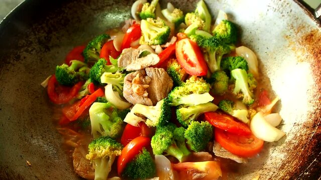 Cooking sweet and sour pork in pan, in door  Chiangmai  Thailand.