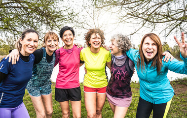 Obraz premium Happy multi generational women having fun together at city park - Multigenerational female friends smiling on camera after sport workout outdoor - Bright filter with focus on faces