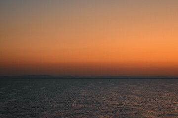 Sunrise sunset orange purple blue pink skies over ocean sea