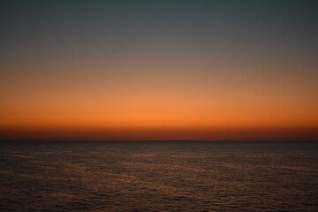 Obraz premium Sunrise sunset orange purple blue pink skies over ocean sea
