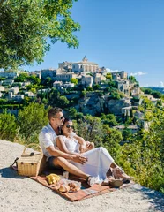 Papier Peint photo autocollant Nice A couple of men and women on vacation in Southern France looking out over the old historical village of Gordes Luberon Provence during summer