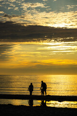 Fototapeta premium parent and child at sunset