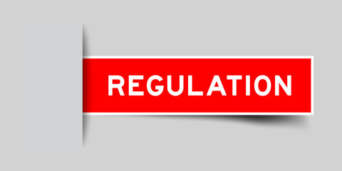Red color square label sticker with word regulation that inserted in gray background