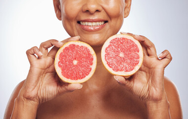 Skincare, hands and happy woman with grapefruit in studio isolated on a white background. Food, natural fruit and mature model with nutrition for wellness, healthy diet and vitamin c for anti aging.