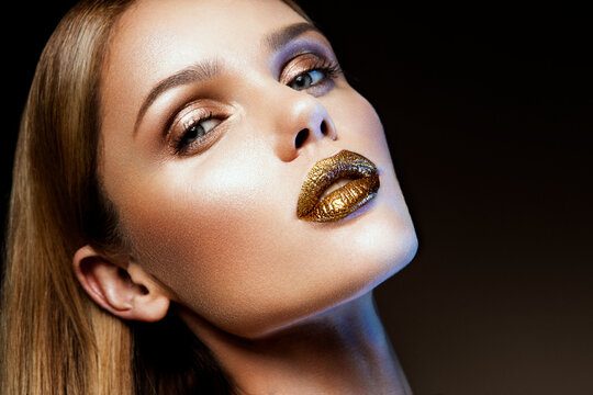 Beautyful girl with gold glitter on her face and body