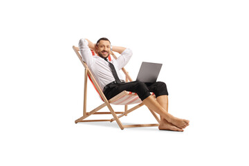 Relaxed bussinesman on a beach chair with a laptop computer