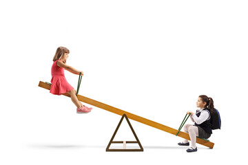 Two girls playing on a seesaw