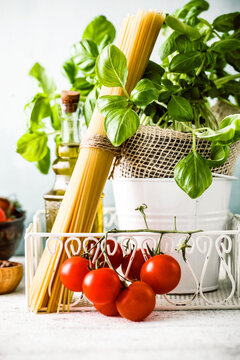 Italian cuisine. Pasta with olive oil, garlic, basil and tomatoes. Spaghetti with tomatoes