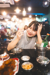 Portrait of drunk asian woman drinking soju or sake at alcohol korean bar restauran