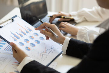 Businesswoman meeting financial advisor discuss business growth chart analysis in financial report and planning investment strategy.