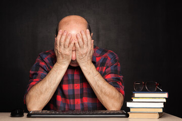 Elderly man covered his face with fatigue.