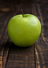 Green organic healthy apple on wooden board. Healthy food