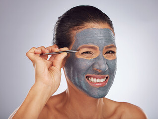 Portrait, eyebrow tweezers and a woman with a face mask for skincare, grooming and female beauty. Sore, cosmetics and a model with gear for hair and a facial isolated on a white background in studio
