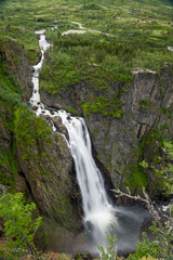 Fototapeta na wymiar Voringsfossen waterfall close view, popular touristic attraction in Norway. Photo from viewpoint on the canyon's cliff. Hardangervidda, Norway.