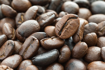 Close up heap of roasted brown coffee beans
