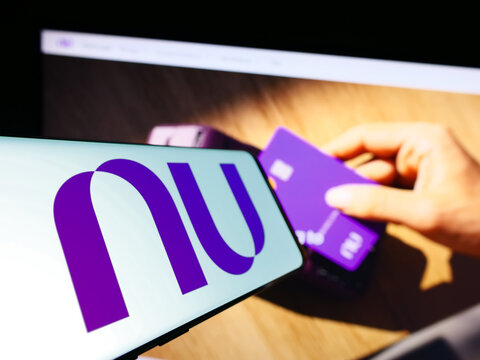 Stuttgart, Germany - 06-30-2023: Cellphone with logo of Brazilian company Nu Pagamentos S.A. (Nubank) on screen in front of website. Focus on center-left of phone display.