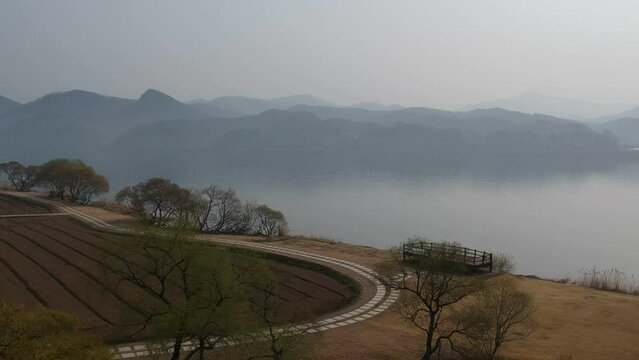Landscape of a river in Winter, mist cover the mountains in background in Aerial view at sunrise, Water Garden near Ungilsan in South Korea